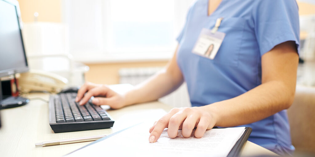 This image shows a healthcare provider filling out paperwork.